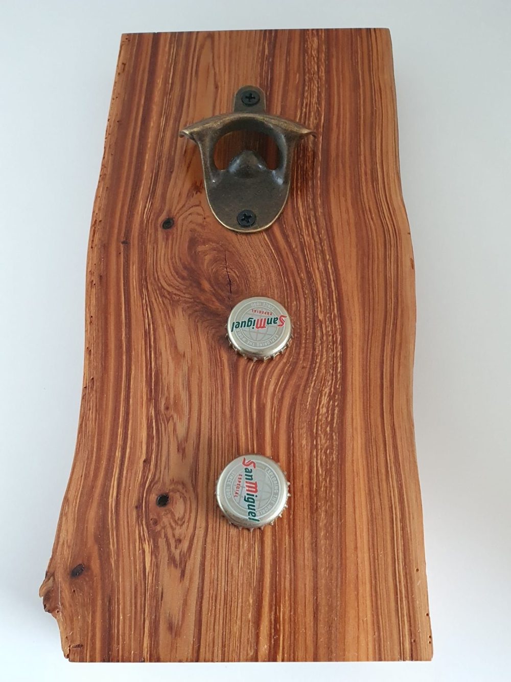 Wall mounted bottle opener with magnetic cap collection